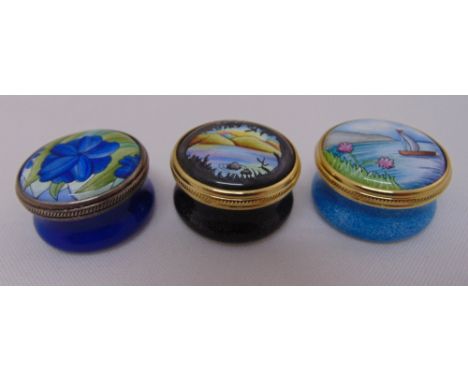 Three Moorcroft enamel pill boxes, signed to the bases
