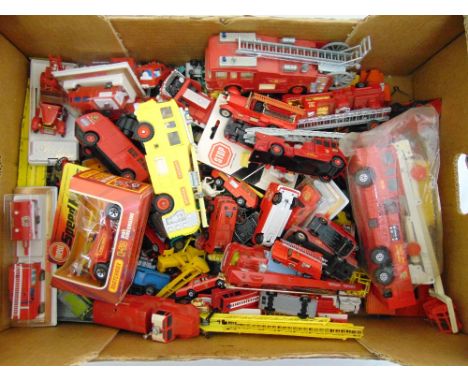 A quantity of play worn diecast cars, trucks and fire engines to include Dinky, Matchbox, Majorette and Solido