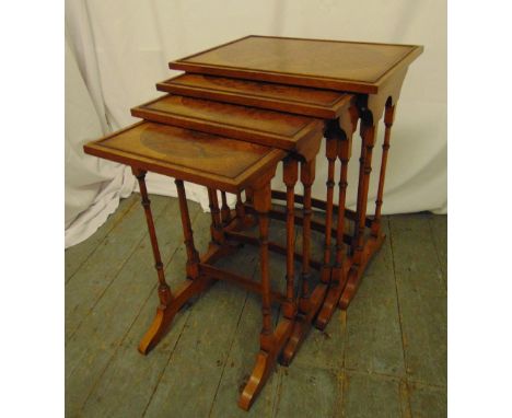 A nest of four rectangular burr walnut side tables on turned tubular supports and outswept bracket feet, 60 x 50 x 35.5cm