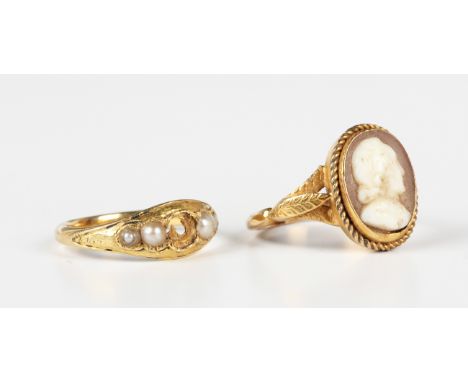 A gold ring, collet set with an oval shell cameo, carved as a portrait of a gentleman, within a wirework surround, detailed '