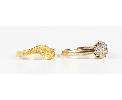 A 9ct gold and diamond cluster ring, detailed '10pts', weight 2.3g, ring size approx Q1/2, and an Asian gold ring in a twisto