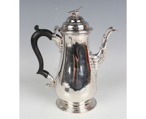 A George III silver coffee pot of baluster form, the domed hinged lid above an ebonized scroll handle and scroll moulded spou