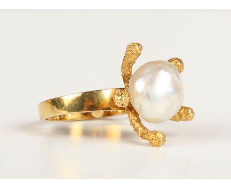 An 18ct gold ring, mounted with a cultured pearl in an abstract design, London 1971, fitted with two sizing beads, weight 9g,