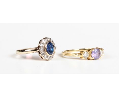 A 9ct gold, sapphire and diamond oval cluster ring, collet set with the oval cut sapphire within a surround of circular cut d