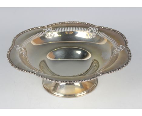 A George V silver circular bowl with pierced decoration within a lobed egg and dart cast rim, raised on a circular foot, Ches