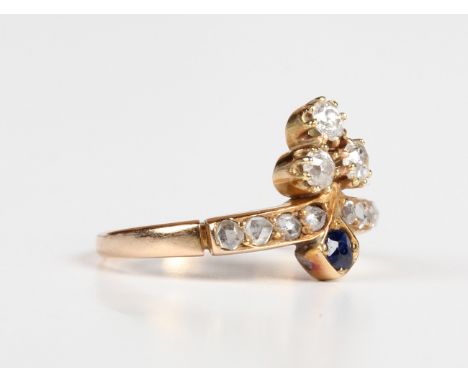 A gold, diamond and sapphire ring with a trefoil shaped motif, mounted with three principal cushion cut diamonds, otherwise s