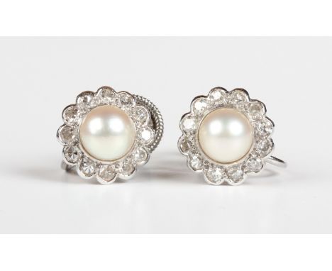 A pair of white gold, diamond and cultured pearl cluster earrings, each mounted with a cultured pearl within a surround of ci