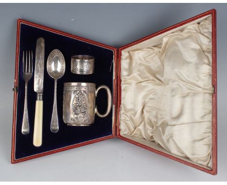 An Edwardian silver five-piece christening set, comprising cylindrical mug with loop handle, decorated in relief with panels 