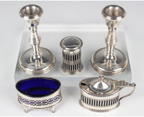 A pair of Elizabeth II silver candlesticks, Birmingham 1978, height 11.2cm, together with a silver mustard and salt, Chester 