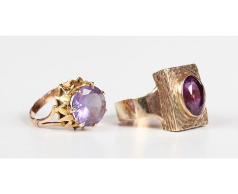 A 9ct gold ring, collet set with an oval cut amethyst on a rectangular ground with a textured finish, Birmingham 1971, weight