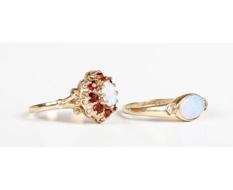 A 9ct gold, opal and diamond three stone ring, collet set with the oval opal between two circular cut diamonds, London 1985, 