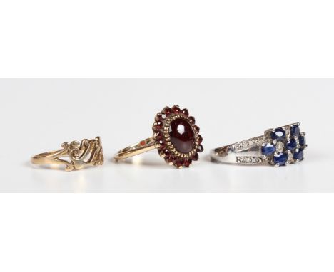 A gold and garnet oval cluster ring, detailed '9ct', ring size approx N, a 9ct gold ring, pierced in a Celtic design, total w