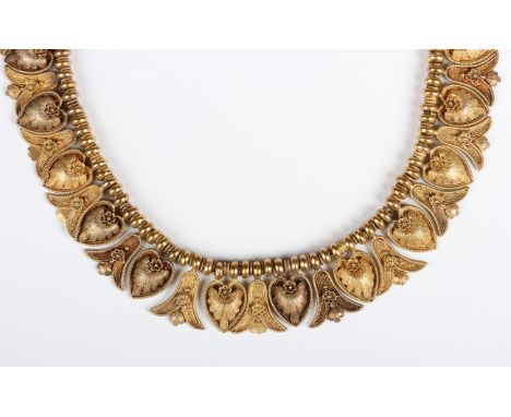 A Victorian gold necklace in a Classical Revival design, the front with alternating heart and palmette shaped drops, on a cir
