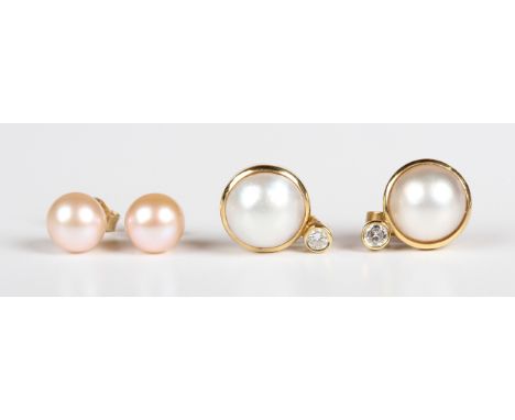 A pair of gold, diamond and cultured pearl earstuds, each mounted with a single cultured pearl below a circular cut diamond, 