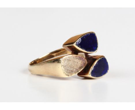 A gold ring in an abstract design with blue enamelled and textured decoration, detailed 'K18', weight 8.4g, ring size approx 