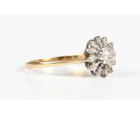 An 18ct gold and diamond cluster ring, mounted with the principal circular cut diamond within a radiating surround, mounted w