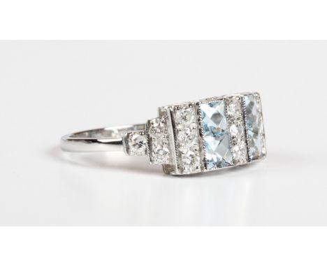 A platinum, aquamarine and diamond ring, mounted with four square cut aquamarines alternating with three rows of three circul