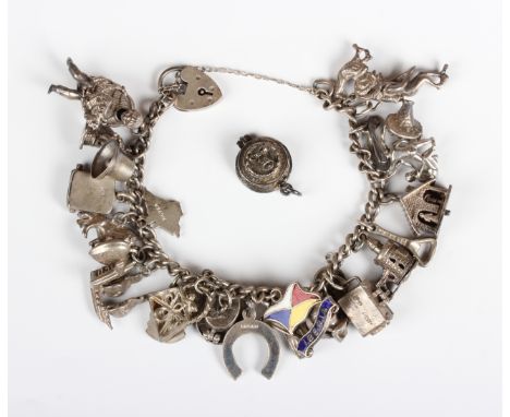 A silver curblink charm bracelet on a heart shaped padlock clasp, fitted with a variety of mostly silver charms, including a 