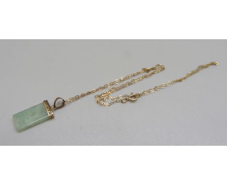 A 9ct gold mounted jade pendant on a fine 9ct gold chain 