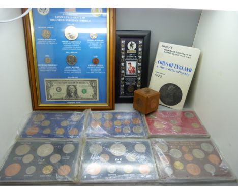 A collection of GB coin sets, framed American coins, Famous Presidents of the USA, a framed Elvis stamp with coin, two coin m