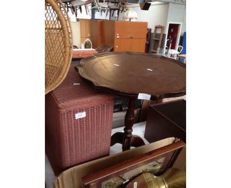 A PINK WOVEN LINEN BASKET AND A TRIPOD TABLE