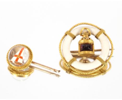 A small 9 carat gold and crystal stick pin, inset with a pennant; and a circular yellow metal nautical brooch, (2)