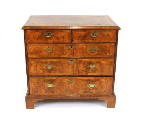 An 18th Century walnut and cross-banded chest, of two short and three long drawers, raised on bracket feet, 98cm wide