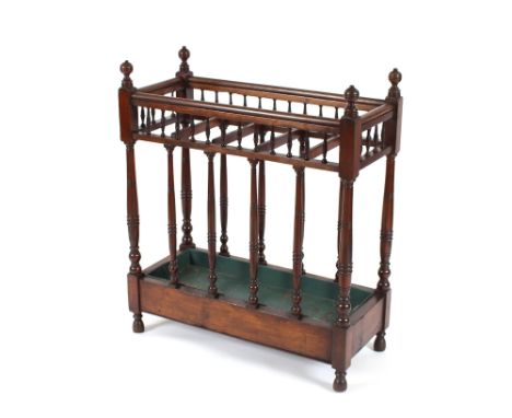 A late Victorian mahogany Country House stick stand, having five divisions and raised on ring turned columns and peg feet, 84