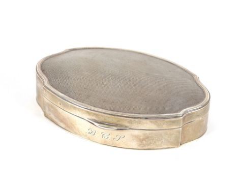 A George V oval silver ring box, the lid with engine turned decoration, monogrammed to the front, London 1927, 13cm