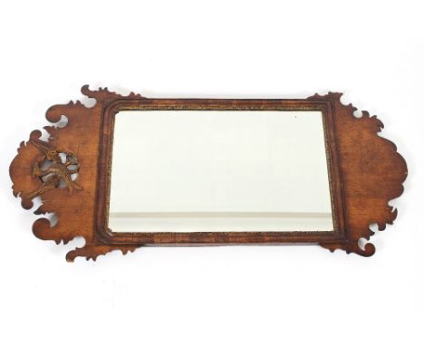 An 18th Century mahogany and gilt decorated wall mirror, in the Chippendale manner, having Ho Ho bird surmount, 77cm wide x 1