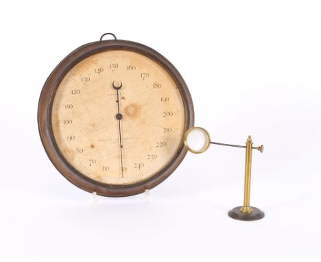 A circular thermometer by Peabody Massachusetts; and a brass cased magnifying stand, (2)