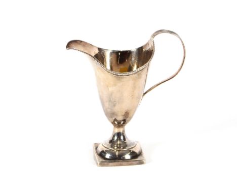 A George III silver cream jug, of helmet shape, London 1785, marks rubbed, 14cm high