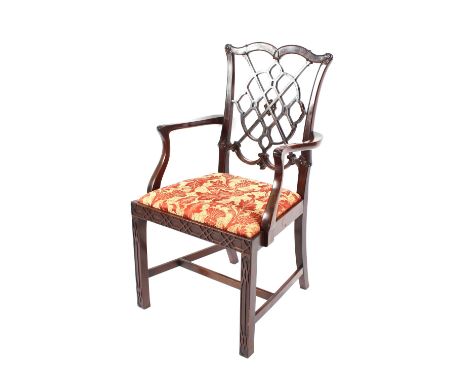 A mahogany Chinese Chippendale design elbow chair, having pierced back, upholstered drop-in seat, raised on fret carved squar