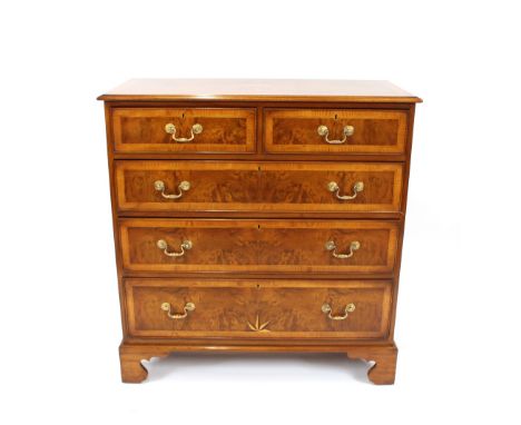 A walnut cross-banded and inlaid chest, fitted two short and three long drawers, raised on bracket supports, 107cm wide x 112