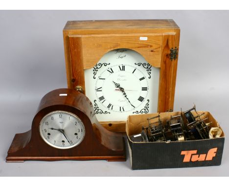 A Westminster chime mantle clock along with a cased modern clock, and sperate spare clock movements