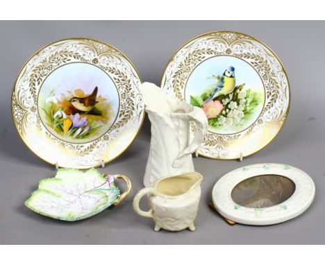 An oval Belleek picture frame and cream jug, along with a Royal Worcester leaf moulded jug and dish and pair of Royal Mint Cl