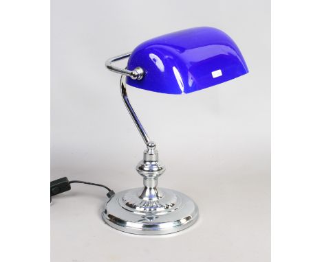 A chrome based desk lamp with blue glass shade.