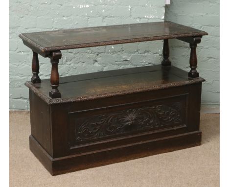 A carved oak monks bench.