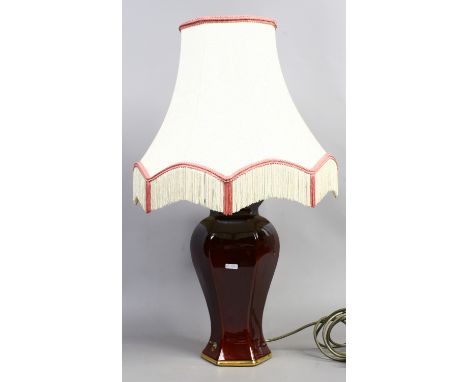 A large hexagonal baluster pottery table lamp decorated in sang de boeuf glaze.