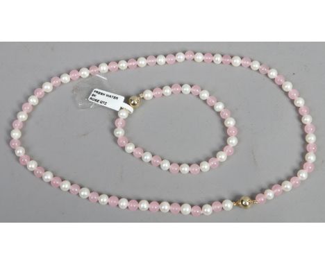A ladies 9ct gold rose quartz fresh water pearl necklace and bangle.