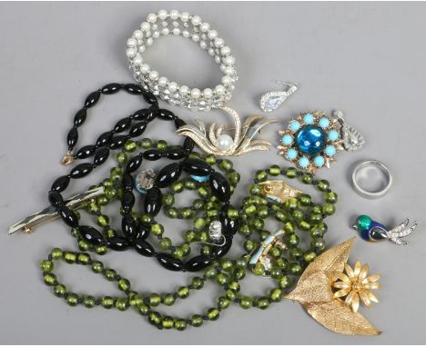 A box of vintage costume jewellery including simulated pearl bangle, enamel bar brooch etc