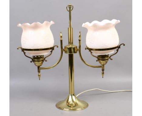 A brass based twin branched tablelamp formed as a students lamp.