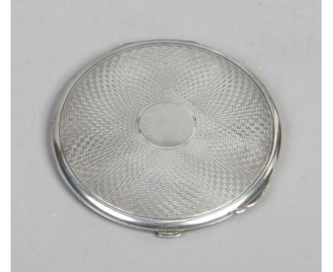 A silver powder compact by Bravingtons Ltd having engine turned engraving and assayed Birmingham 1935