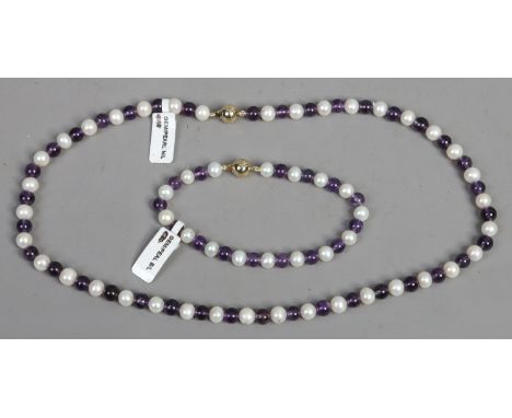 A ladies 9ct gold cultured fresh water and amethyst pearl necklace and bangle.