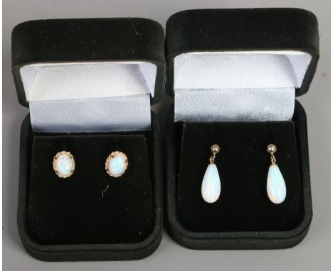 Two cased pairs of opal and gold earrings.