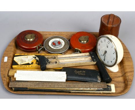 A tray of vintage measuring equipment to include Rabone tape measures, Smiths alarm clock, vintage spectacles etc.