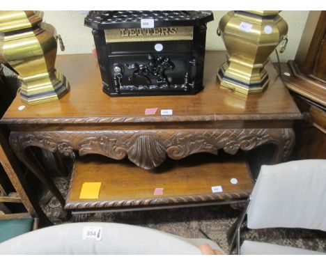 A CHIPPENDALE STYLE MAHOGANY SIDE TABLE the rectangular top with gadrooned rim above a carved frieze on cabriole legs with cl