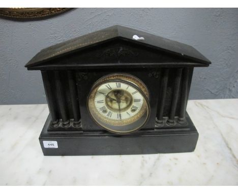 A BLACK SLATE MANTLE CLOCK of architectural form the dial with Roman numerals between reeded columns on platform base 33cm (h