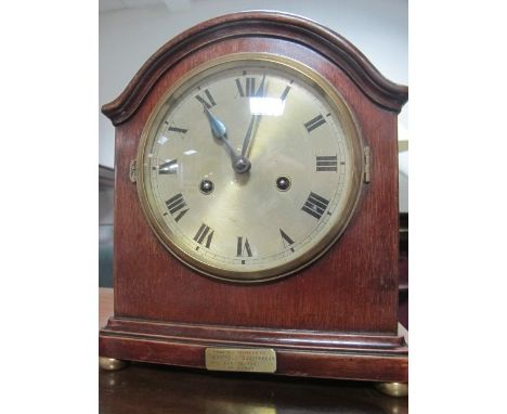 A MAHOGANY CASED MANTLE CLOCK the rectangular arched case with silver dial and Roman numerals raised on brass bun feet 28cm h