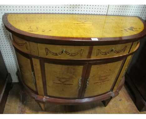 A GOOD WALNUT INLAID COMMODE of demi-lune outline the shaped moulded top above a frieze drawer and cupboards between moulded 